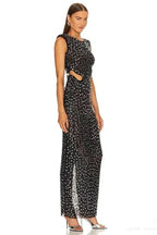 Side view of a black sequined mesh dress with a thigh-high slit and padded shoulders