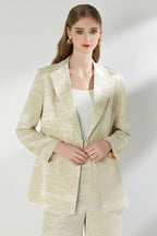 Close-up of the woman's cream jacquard blazer.