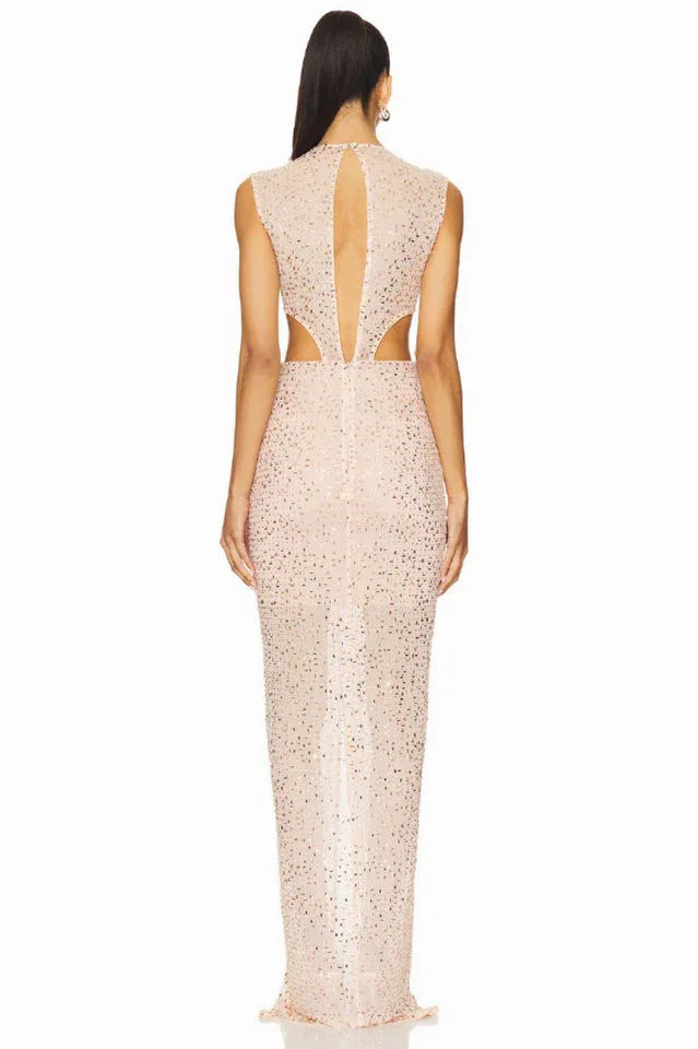 back view of a model in a blush pink sequined gown, showing a keyhole back and cut-out details