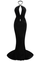 Front view of a black velvet mermaid gown with a deep V-neck and embellished halter neckline.