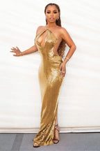 woman in gold sequin halter dress with cut-outs