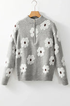 A gray floral print quarter-zip knit sweater with a mock neck, long sleeves, and ribbed cuffs and hem, displayed on a hanger.