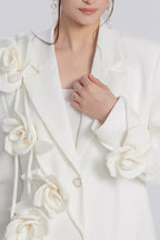 Close-up of the floral embellishments on a white blazer dress