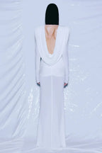Back view of a white draped gown revealing an open back.