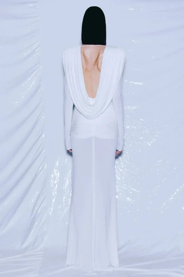 Back view of a white draped gown revealing an open back.