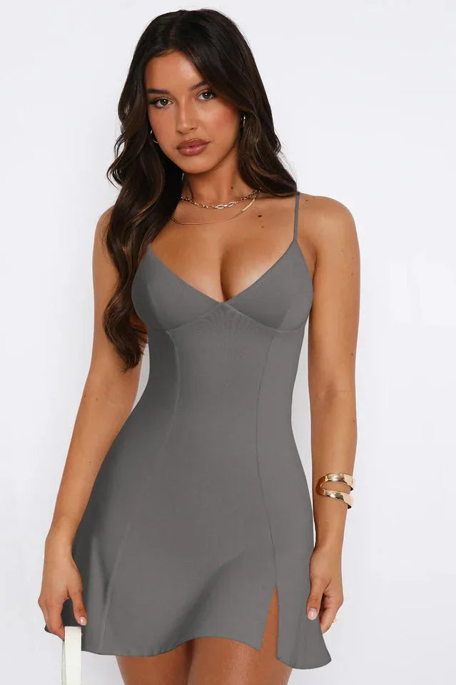 Woman wearing a grey sleeveless mini dress with spaghetti straps and a V-neckline, shown from the front.