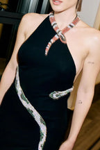 Detail of a black dress with a snake embellishment