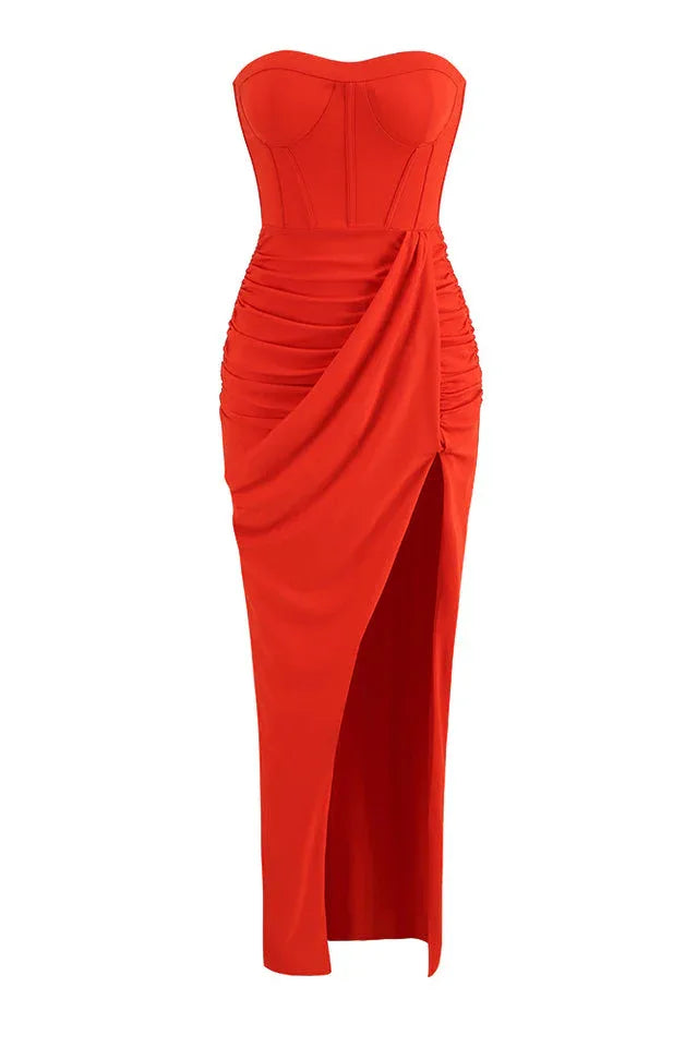 Front view of the strapless orange ruched gown with a high slit