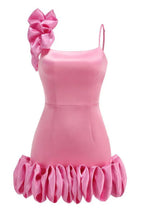 back view of a bright pink mini dress with a large ruffle on one shoulder and a ruffled hem, showing zipper detail