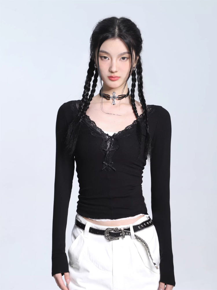 Model wearing a black ribbed long-sleeve top with lace trim and lace-up detail, paired with white cargo pants.