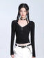 Model wearing a black ribbed long-sleeve top with lace trim and lace-up detail, paired with white cargo pants.
