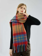 Woman adjusts a multi-colored plaid scarf around her neck