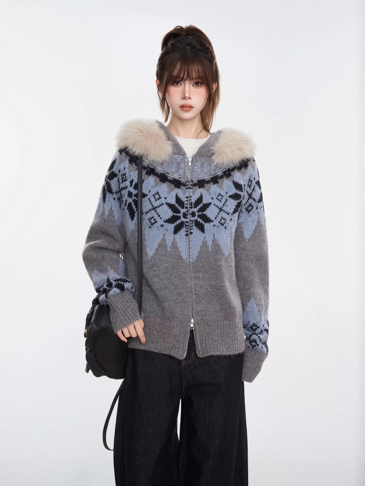 Woman wearing a grey and blue Fair Isle knit zip-up cardigan with a faux fur trim hood and black wide-leg jeans