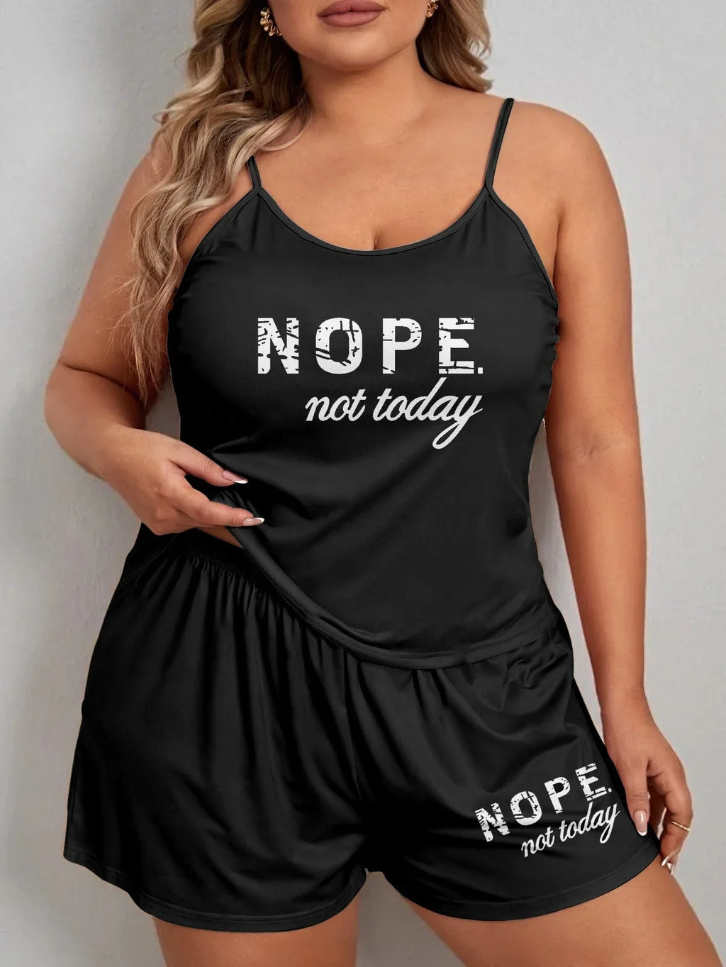 Front view of a woman in a black pajama set with 'NOPE. not today.' graphic print.
