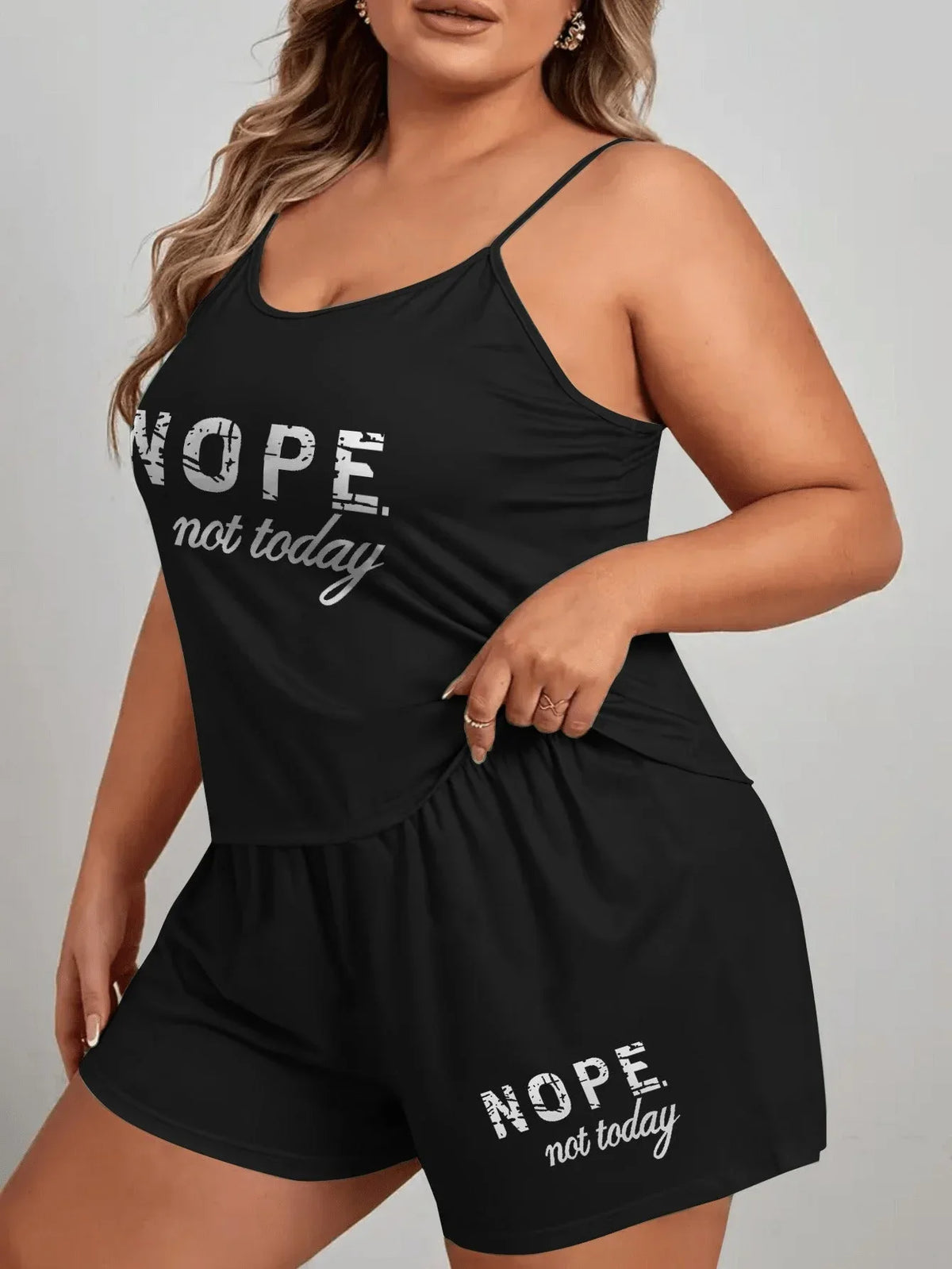 Woman wearing a black pajama set with 'NOPE. not today.' graphic print on the camisole and shorts. Main image