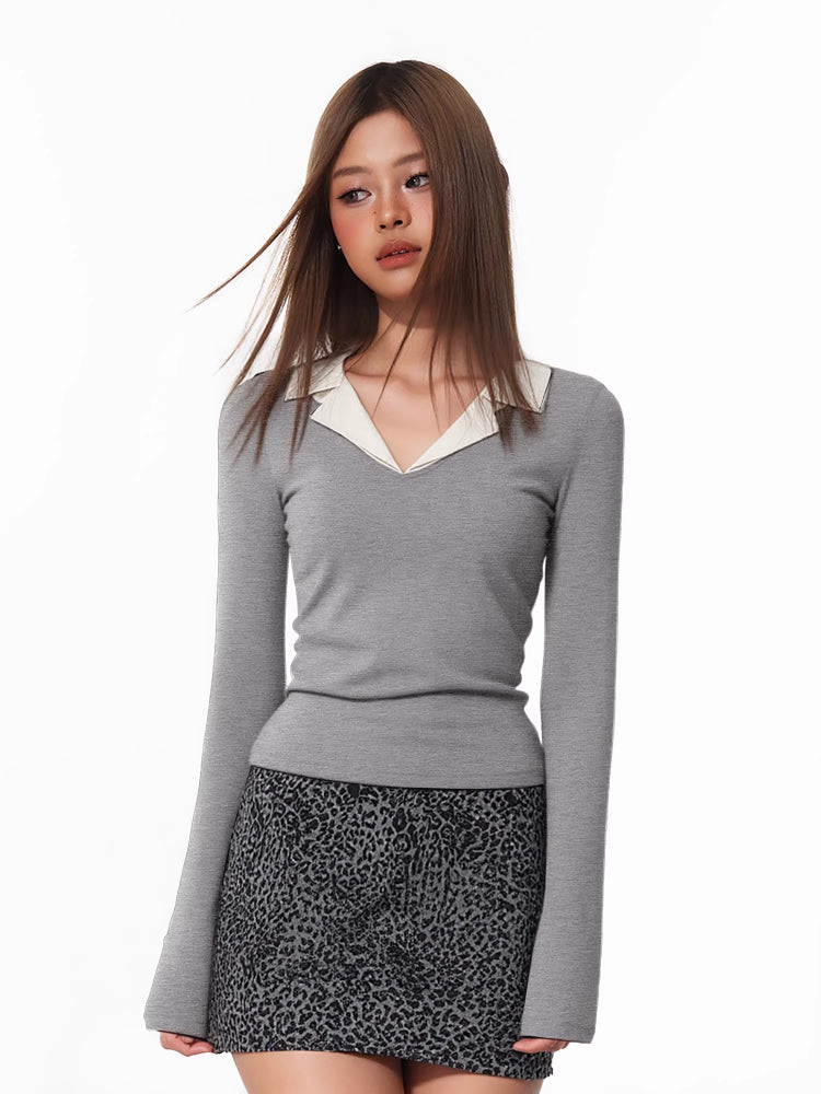 Model wearing a grey long-sleeved top with a white contrast collar and a leopard print skirt.