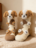 Two cream-colored knit socks with 3D plush dog appliques, paws, and brown patches, standing upright.