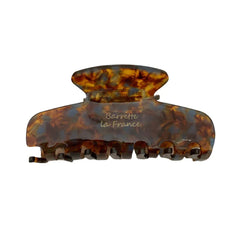 A tortoiseshell hair claw clip with the text 'Barrette la France' embossed on it.