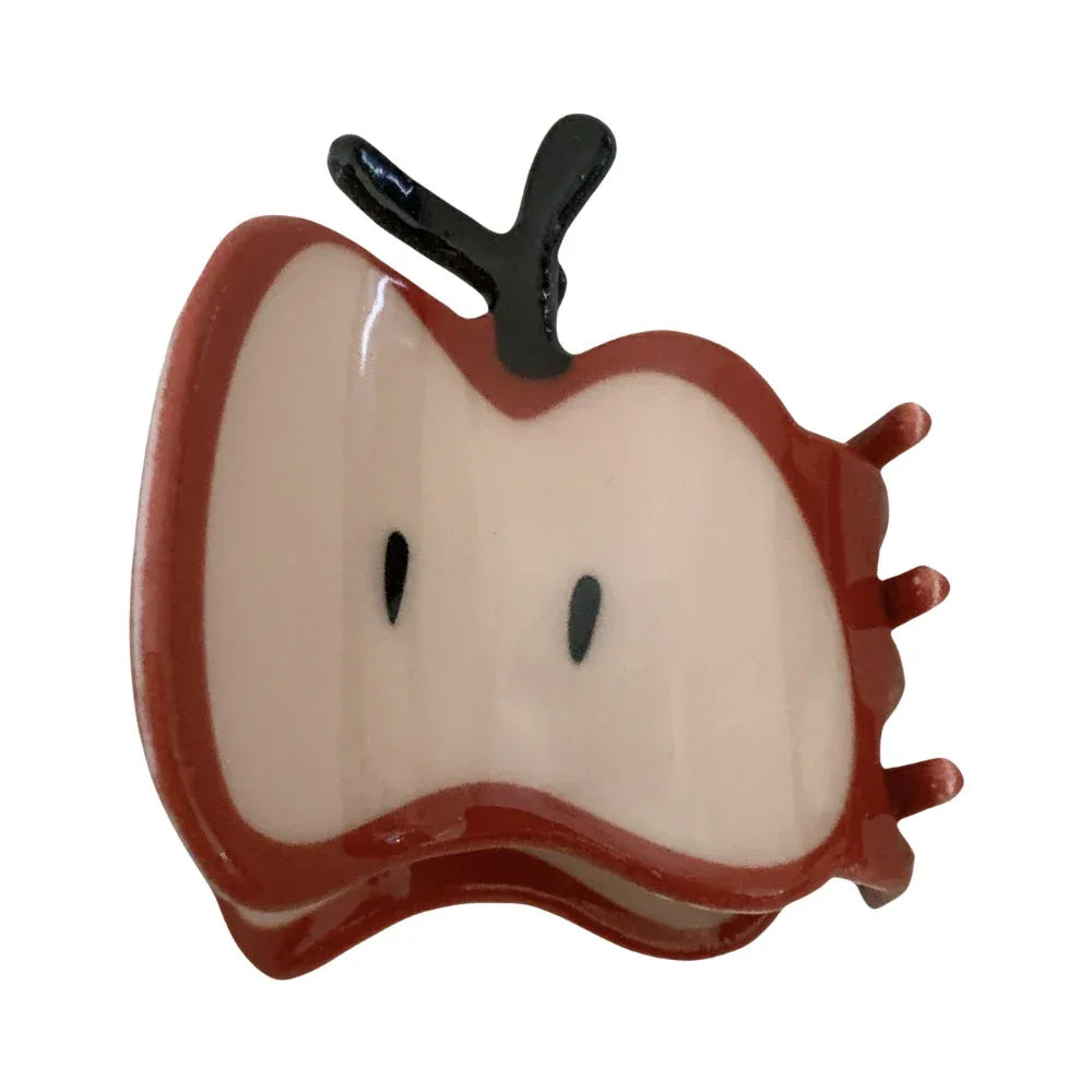 A single red apple slice hair claw clip with a glossy finish and black stem, against a white background.