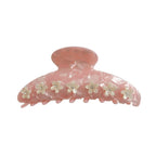 Pink marbled claw clip with white floral accents and clear gemstones.
