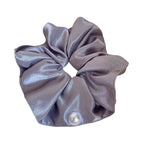 A single gray satin scrunchie with a pearl accent.