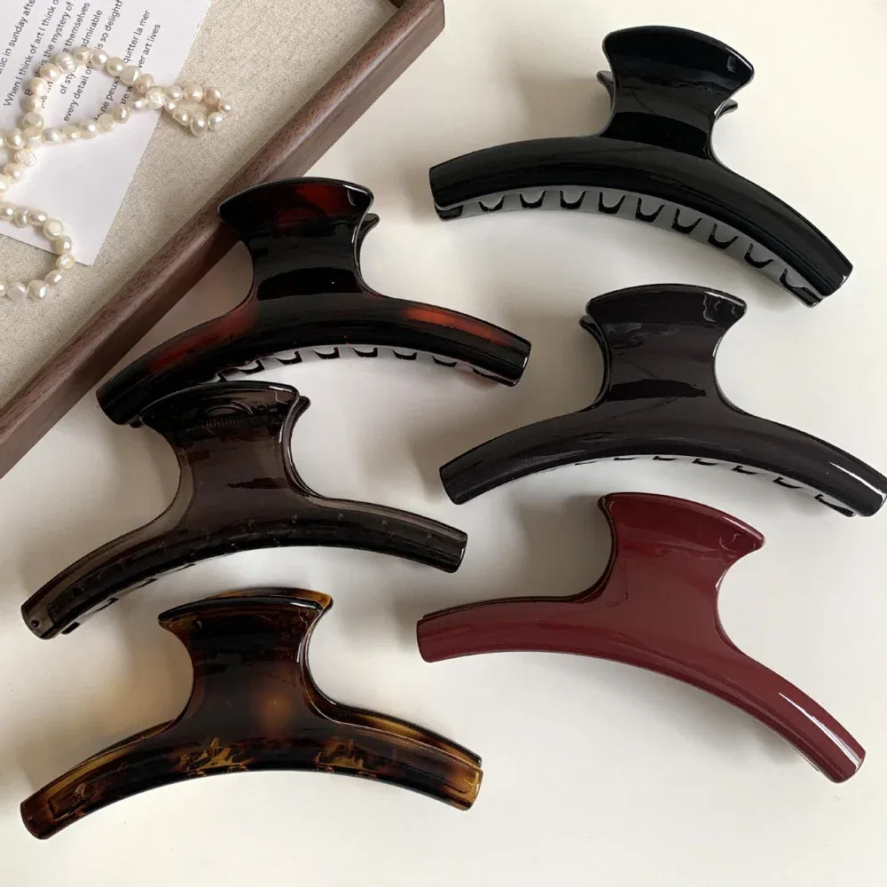 set of hair claw clips in various colors including black, tortoiseshell, and burgundy