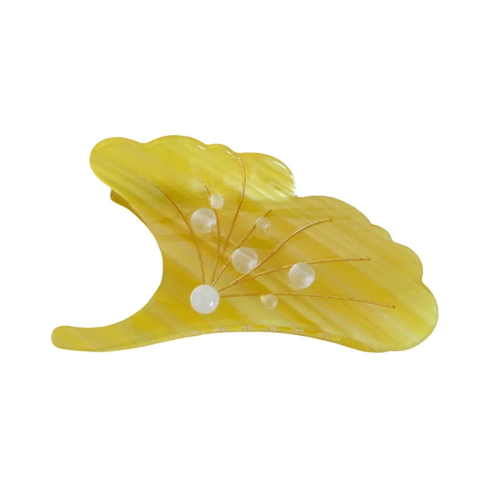 A single yellow ginkgo leaf-shaped hair claw clip with translucent beads and gold wire accents, isolated on a white background.