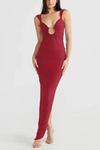 Woman wearing a long red sleeveless dress with a deep V-neck and a cutout detail at the bust.