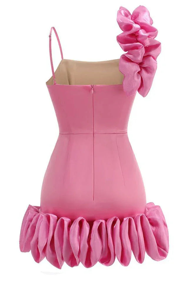 front view of a bright pink mini dress with a large ruffle on one shoulder and a ruffled hem