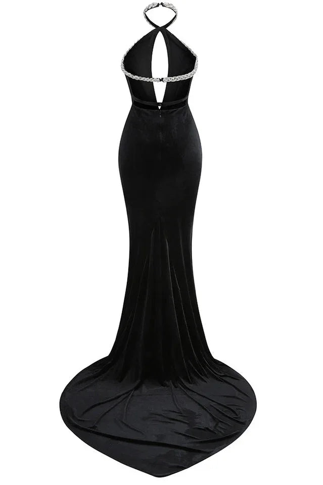 Back view of a black velvet mermaid gown with a low back and long train.