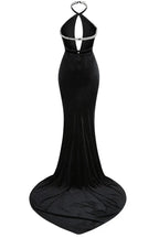 Back view of a black velvet mermaid gown with a low back and long train.