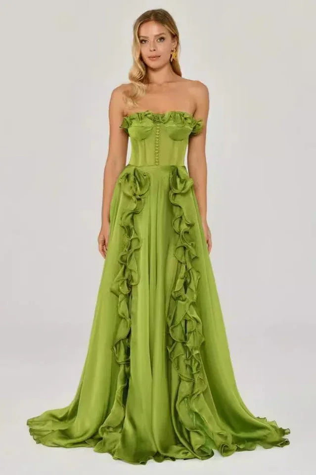Woman in a green strapless satin gown with ruffled detailing and a high slit, front view. Main image