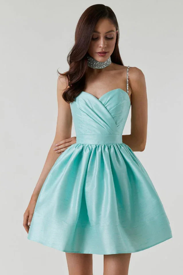 Woman wearing a short, aqua satin dress with a sweetheart neckline, embellished spaghetti straps, and a full A-line skirt. Main image