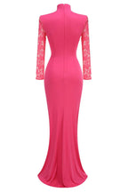 Back view of a hot pink satin gown with lace sleeves and a mermaid hem.