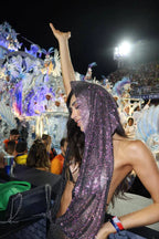 Woman celebrating at an event in a sparkling hooded outfit