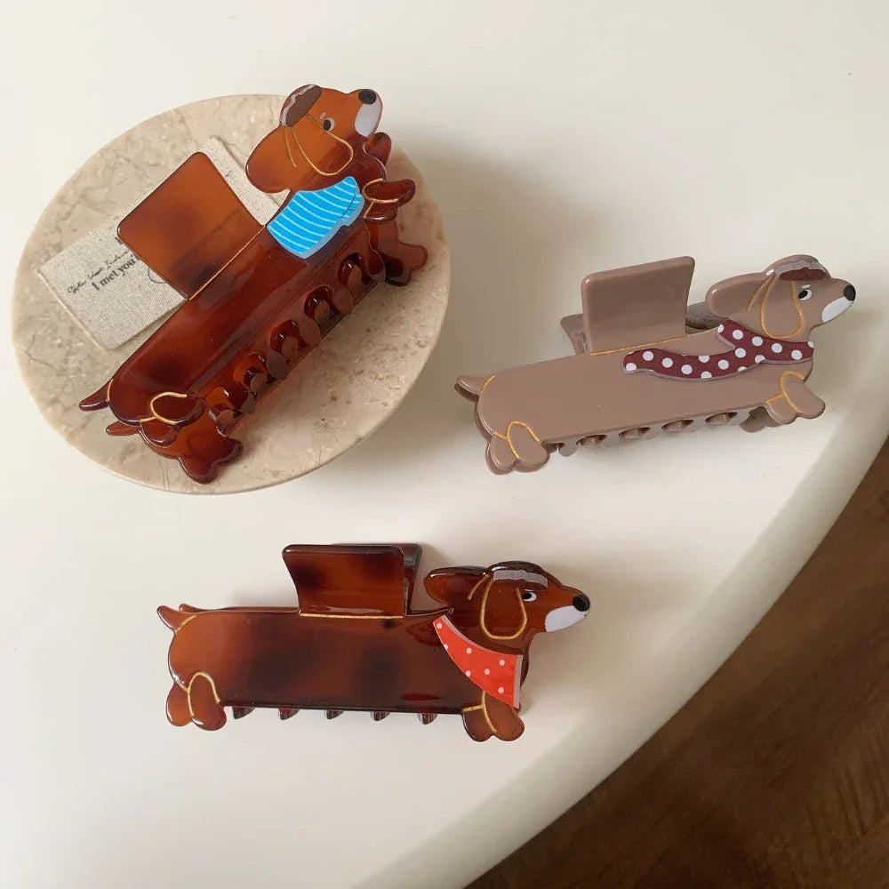 Three dachshund hair claw clips in various colors and scarf patterns