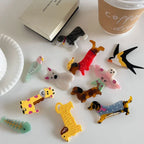 Assortment of acrylic animal-shaped hair accessories on a table