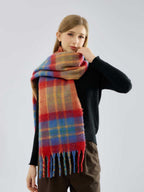 Woman touching her scarf, which has a multi-colored plaid pattern