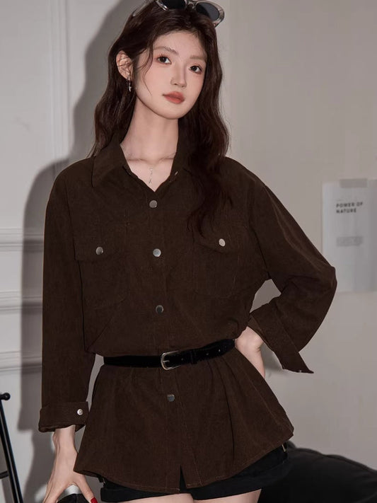 Woman wearing a brown corduroy shirt dress with a black belt