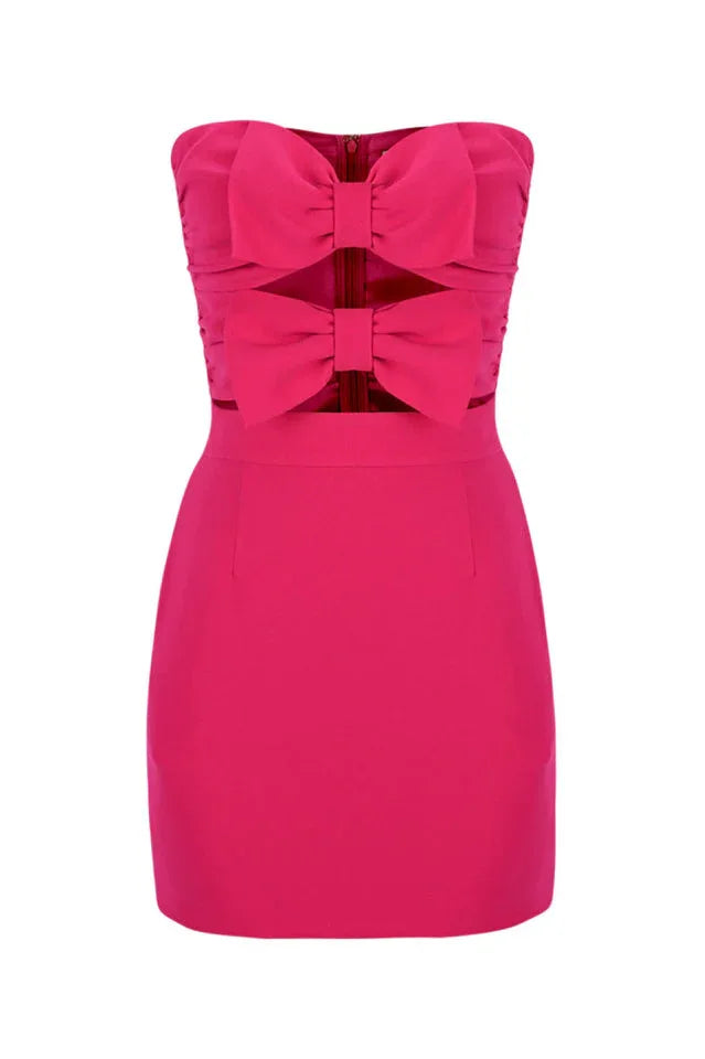 Front view of a pink strapless mini dress with a fitted bodice adorned with two large bows and a simple skirt.