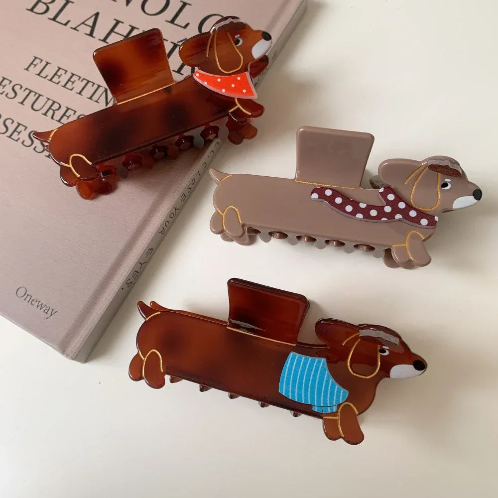 Collection of dachshund hair claw clips with different scarf designs on a table