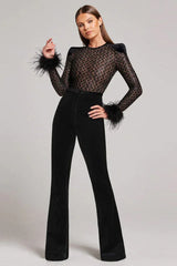 Woman modeling a black sequined mesh top with feathered cuffs and black velvet flared pants from the front.