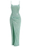 Front view of a mint green sequined gown with a high slit and ruched detail.