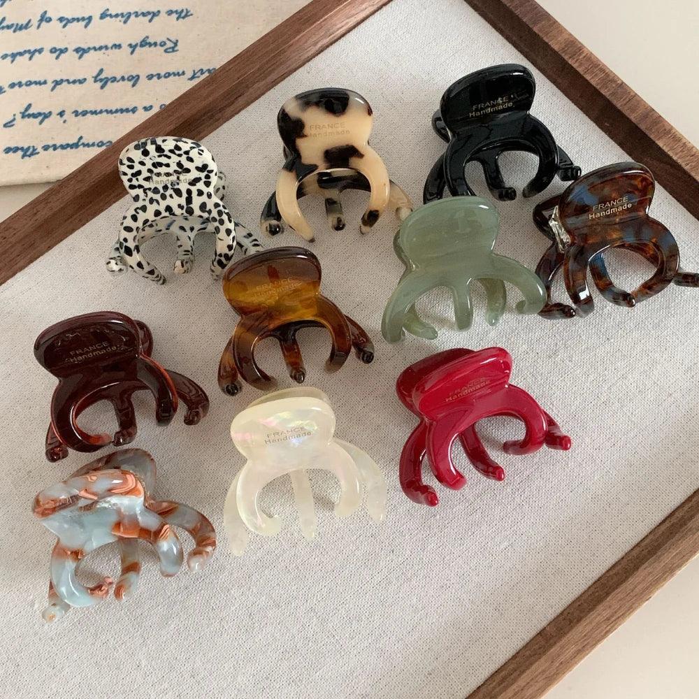 Collection of octopus-shaped hair claw clips in various colors and patterns