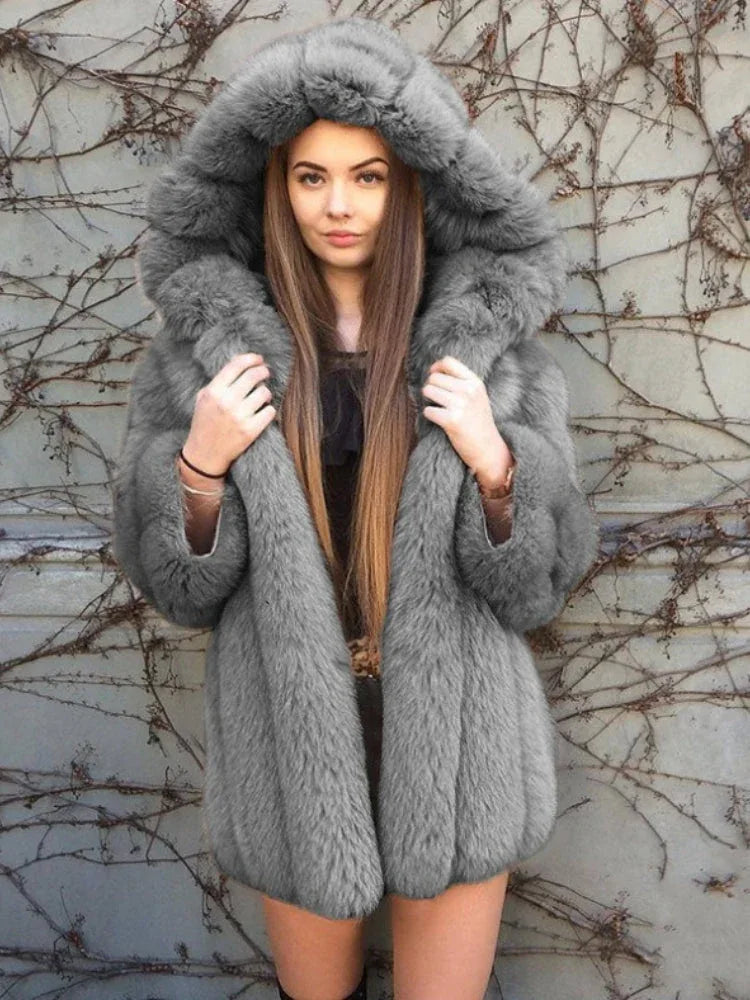 Woman wearing a grey faux fur hooded coat