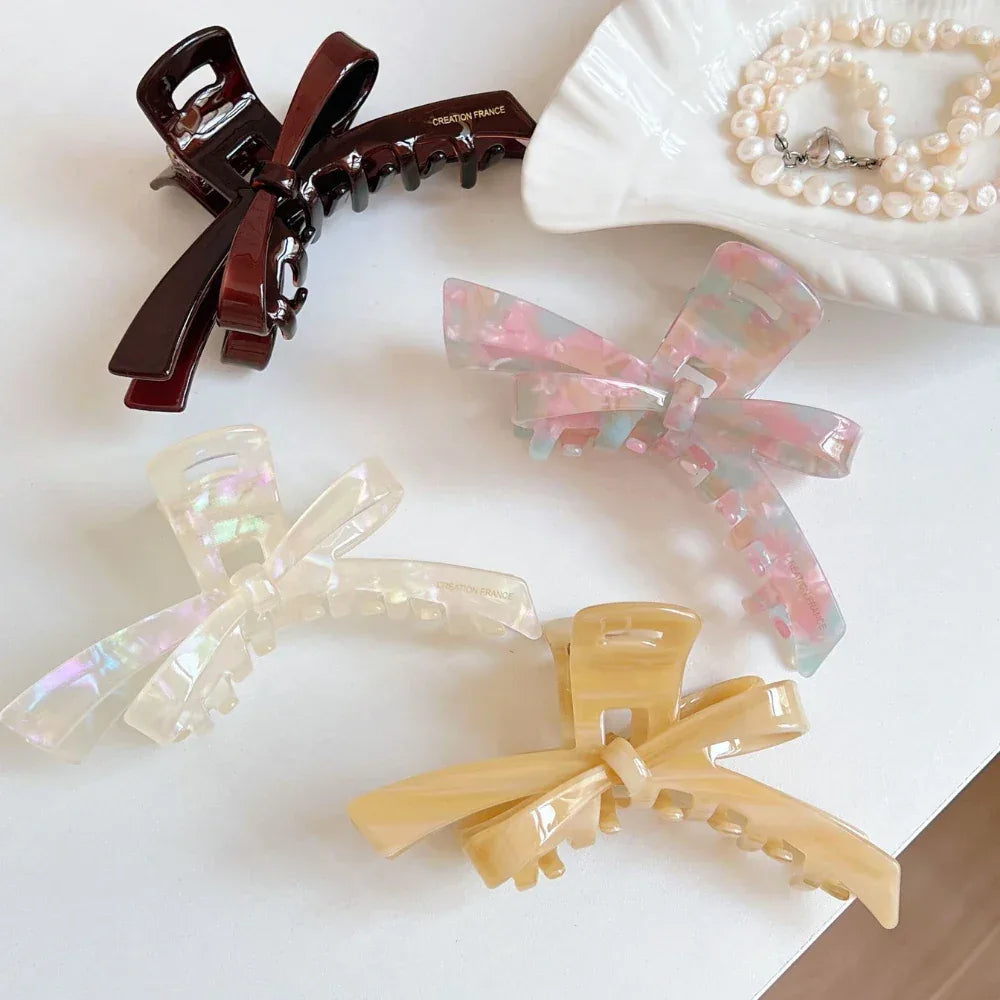 Close-up of marbled bow claw hair clips with pearls