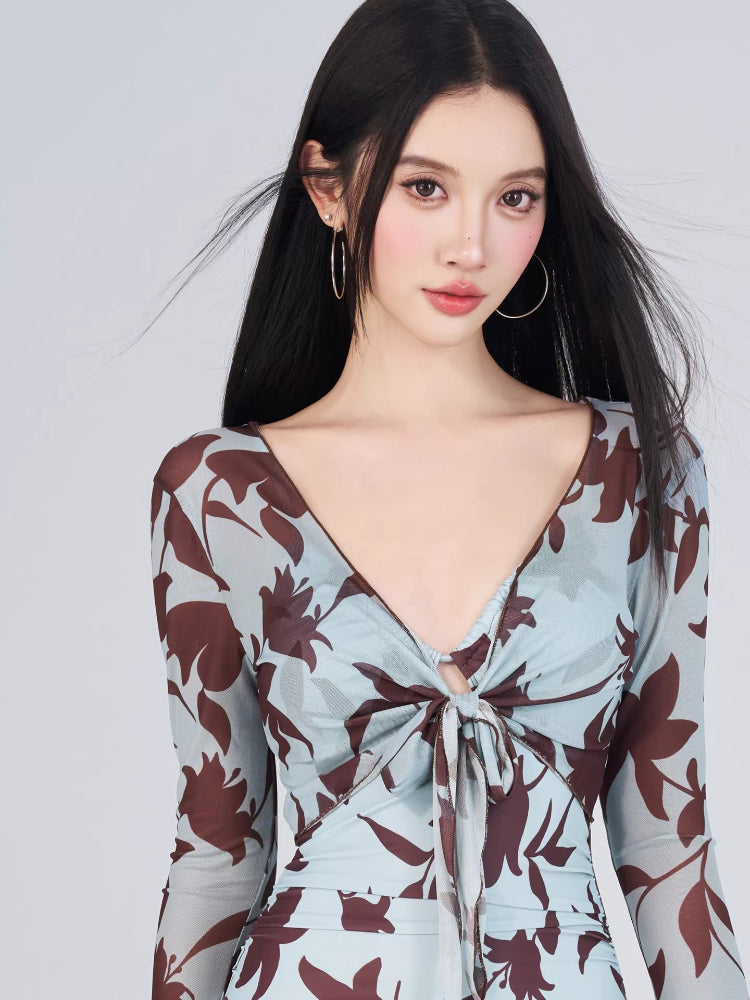 Close-up of the V-neckline and tie-front detail of the floral print swimsuit.