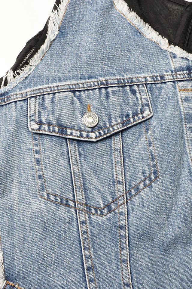 Close-up detail of the denim pocket and button on the deconstructed denim overlay of the dress