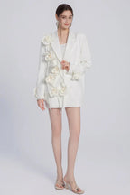 Model showcasing a white blazer dress with intricate floral details