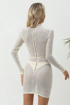 back view of a woman in a white sparkly sheer dress with a zipper closure